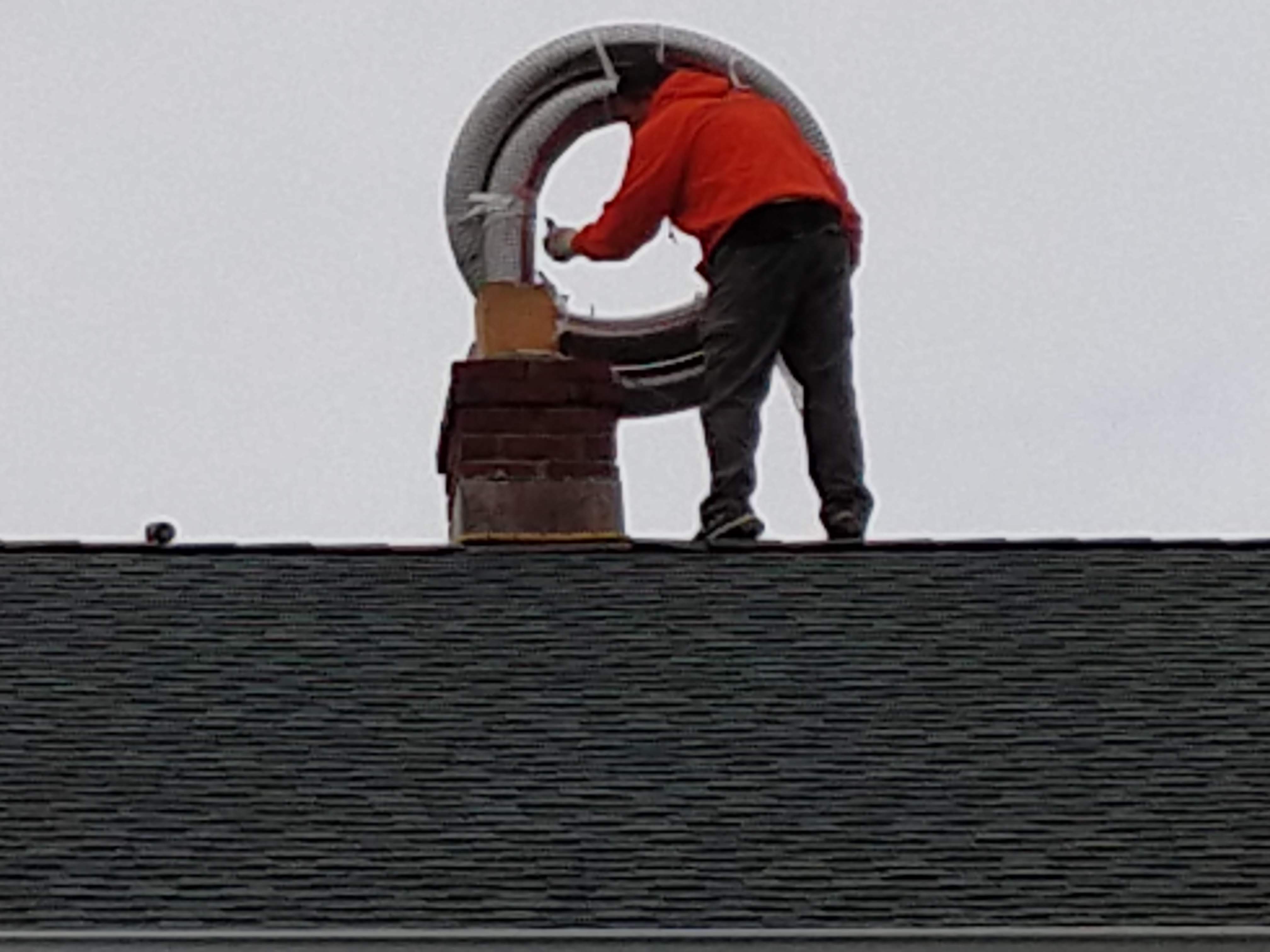 Flexible stainless chimney liner being installed in Hicksville, New York